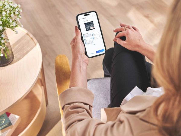 Person using Home Connect app on mobile phone