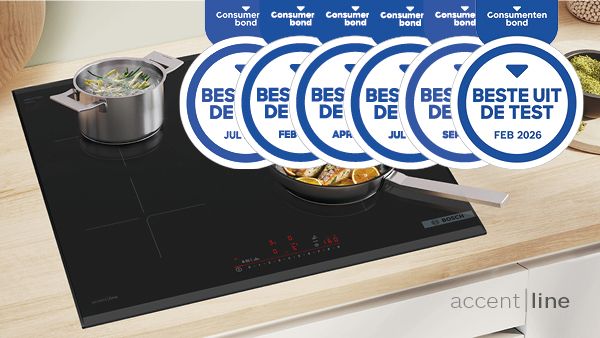 Moderne inductiekookplaat met een koekenpan met vis en een pan met groenten, bekroond met prijzen voor de beste prestaties.