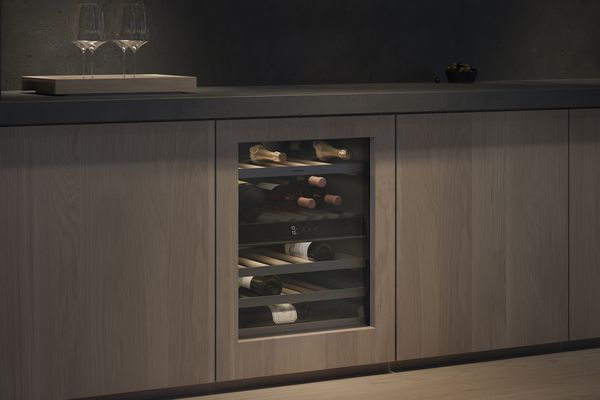A gaggenau 200 series under counter wine cabinet in a modern luxury kitchen