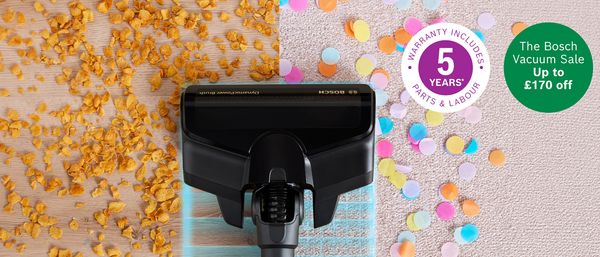 A Bosch vacuum cleaner head cleaning a floor, with one side covered in cereal and the other in confetti, highlighting its cleaning power, alongside promotional badges for a 5-year warranty and a sale.