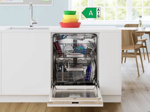 Dishwasher with door open showing full contents inside and A rated energy overlay above