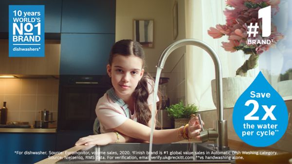 Child turning on kitchen tap with water coming out