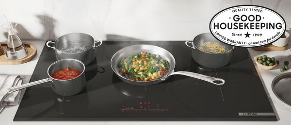 Bosch induction cooktop with pots and pans of  food good housekeeping seal banner