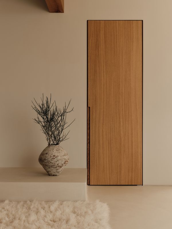 Interior detail shot of a wooden door and clever approach to a minimalist handle 