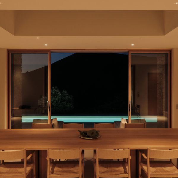 Interior shot of dining room looking out across the dark landscape in the SR house 
