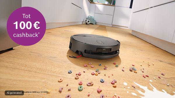 Robotstofzuiger rijdt over een houten keukenvloer tussen gemorste kleurrijke ontbijtgranen en gemorste melk; linksboven een paarse cirkel met de tekst "Tot 100&euro; cashback*".