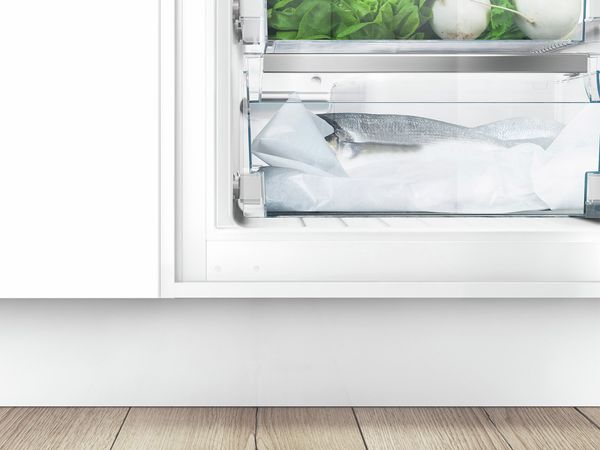 How do you achieve optimum energy efficiency with an upright freezer? 