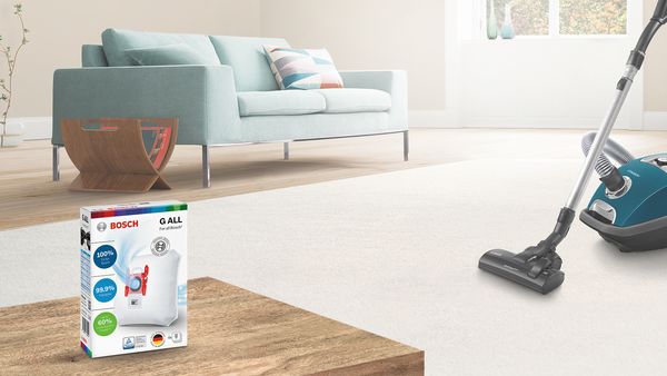Vacuum cleaner and a dust bag in a living room.