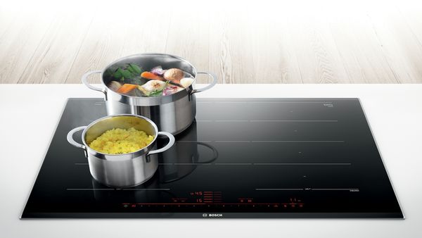 pot of vegetables sitting on an induction cooktop