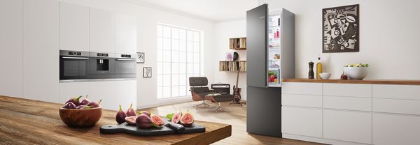 Colourful kitchen in black with coloured fridge freezer by Bosch.