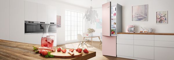 Colourful kitchen in rose with coloured fridge freezer by Bosch.