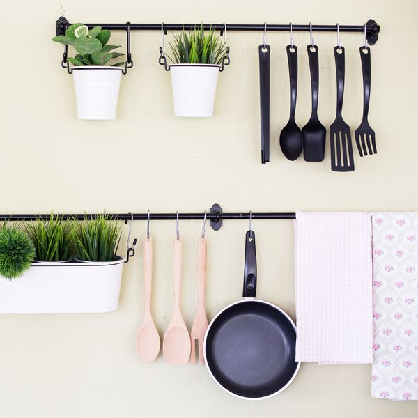 Kitchen tools and plants hung on rods