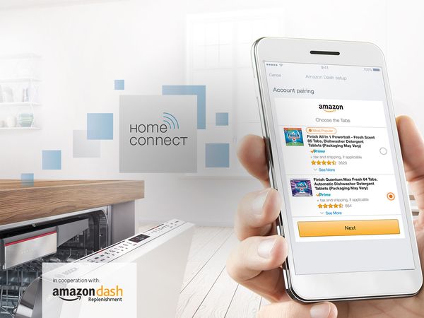 Home Connect Phone with Amazon on screen in ktichen with Bosch Dishwasher
