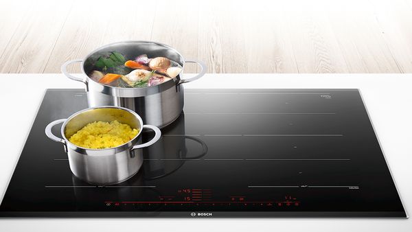 Bosch Induction Hob with pots on top full of cooking produce.