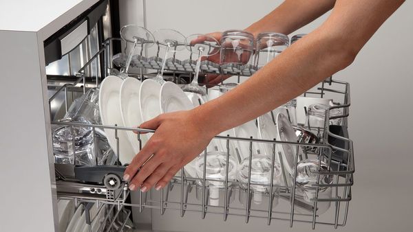 Full Dishwasher Rack Being Moved