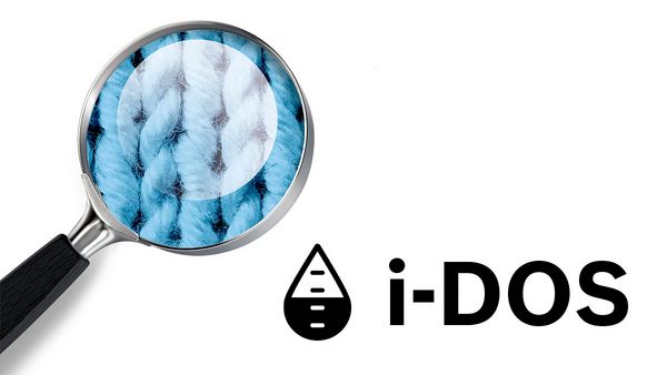 magnifying glass looking at fabric with i-DOS logo