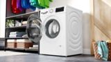 Bosch washer with EcoSilence Drive motor, relaxation space in background